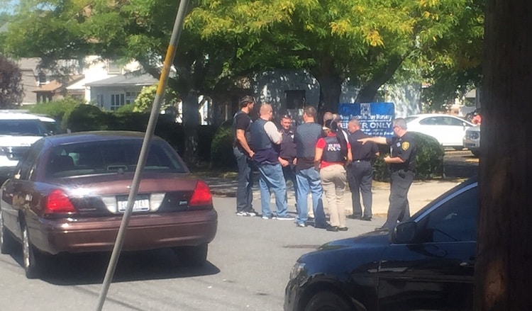 New Rochelle police on scene outside New Rochelle Day Nursery, location of a shooting involving two cars.