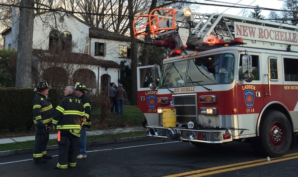 Family gathers outside their burned out home at 291 Lincoln Avenue