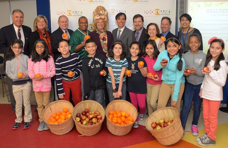 Photo caption: Standing with students from Columbus Elementary School in New Rochelle are, from left, Charles Coletti, District Coordinator for U.S. Department of Education Carol M. White PEP Grant; Food Bank for Westchester President and CEO Ellen Lynch; George Oros, Chief of Staff for Westchester County Executive Robert Astorino; rapper James McBride, who goes by the name Mr. Deep Positivity;” Joy Feldman, author of “Is Your Hair Made of Donuts;” New Rochelle Mayor Noam Bramson; Dr. Brian Osborne, Superin