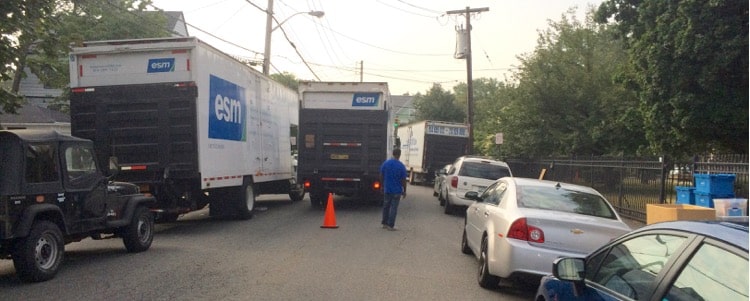 Movers on Mount Joy Place relocating Webster School classrooms to Holy Family School