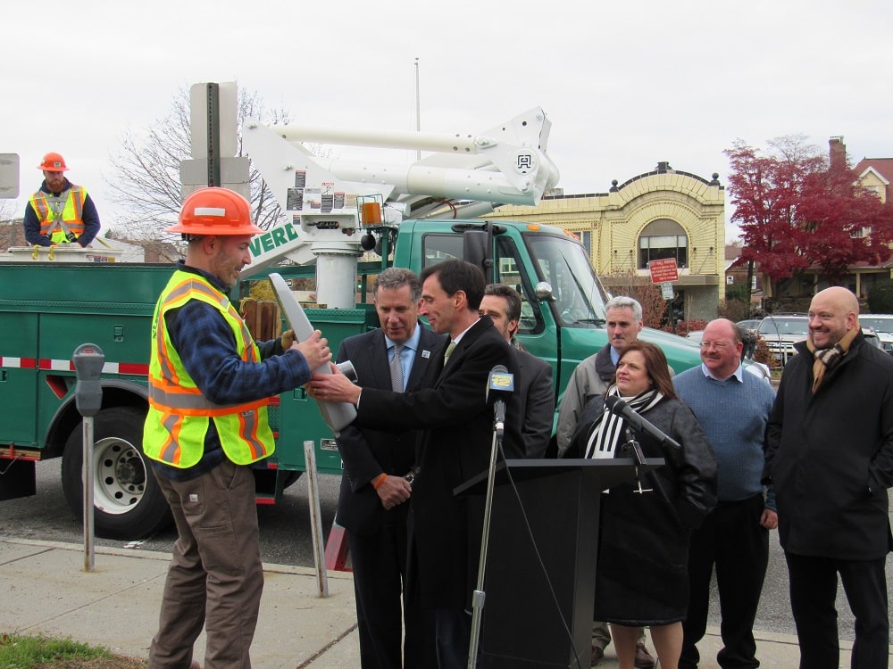 Mayor Noam Bramson hands off a new LED lighting fixture for installation outside City Hall. Over the next six months, the City will replace all 7,000 streetlights with LED bulbs.