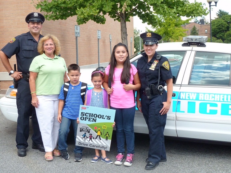 Police Officer Erick Aguilar and Detective Lillian Sanchez helped to launch AAA’s “School’s Open – Drive Carefully” campaign at Police Headquarters in New Rochelle with local school children, (left to right) Armando Sanchez, Megan O’Rourke and Natalia Sanchez.  Donna Galasso, Assistant Director, Traffic Safety represented AAA at the ceremony.