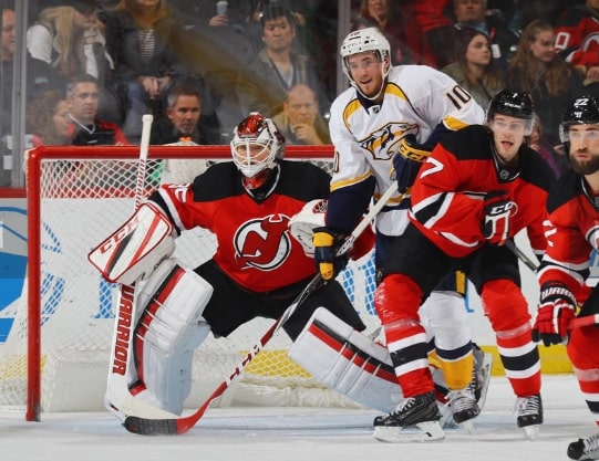 Cory Schneider #35 and Jon Merrill #7 of the New Jersey Devils defend against Colton Sissons #10 of the Nashville Predators during the second period at the Prudential Center on December 20, 2016 in Newark, New Jersey. (Bruce Bennett | Getty Images)