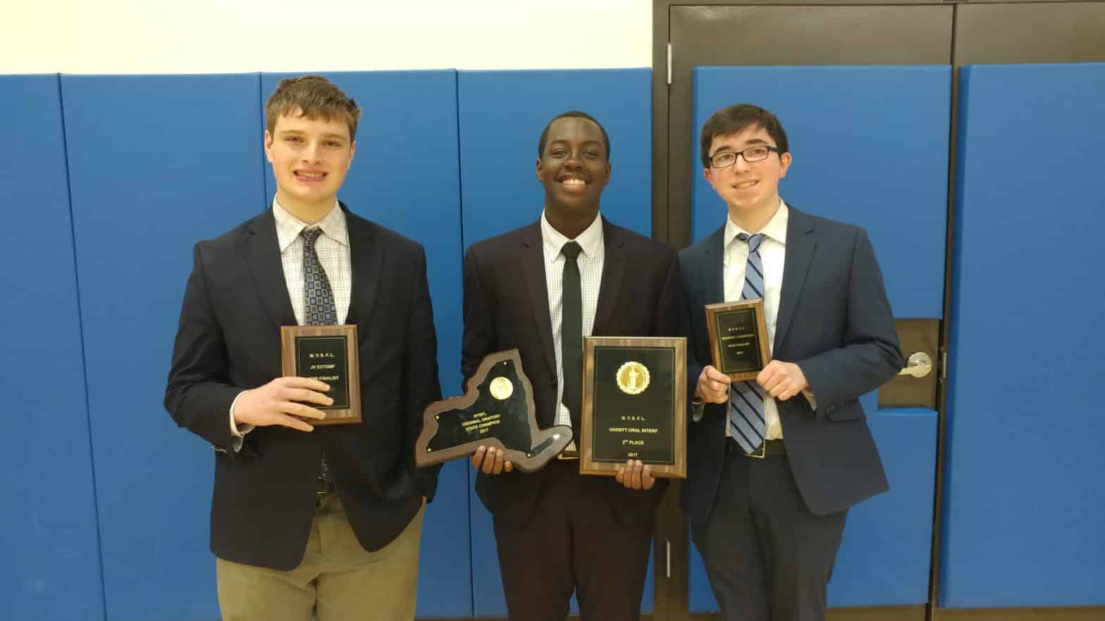 New York State Original Oratory Champion Noah Darden (center), along with state extemporaneous speaking semi-finalist Jacob Cannon (left) and state student congress semi-finalist Timothy Brisson (right)