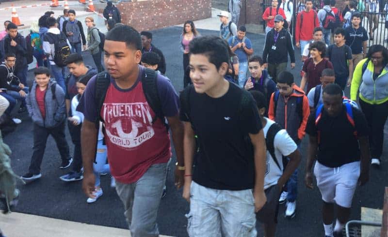 Students stream into New Rochelle High School Friday morning. It was the first day of classes for juniors and seniors