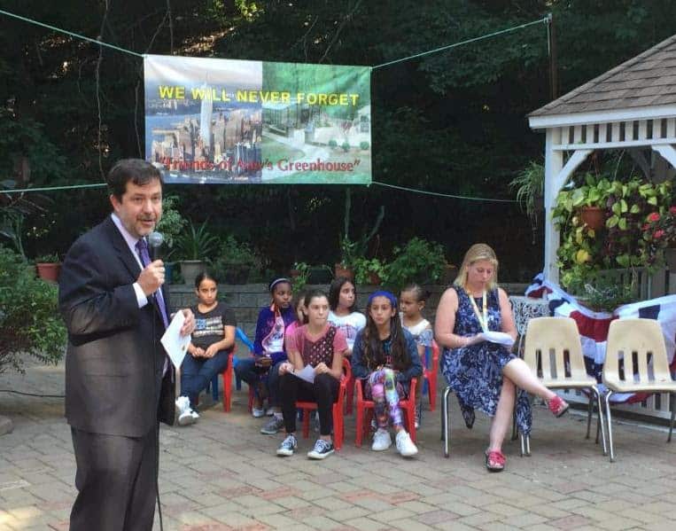 Superintendent Dr. Brian Osborne addresses the gathering at Amy's Greenhouse.