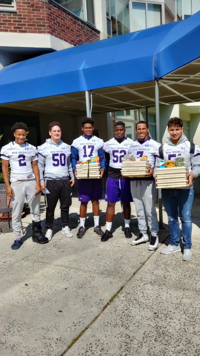 Players from the New Rochelle Varsity football team delivering meals to patients at Montefiore Hospital. Photo Credit: Contributed