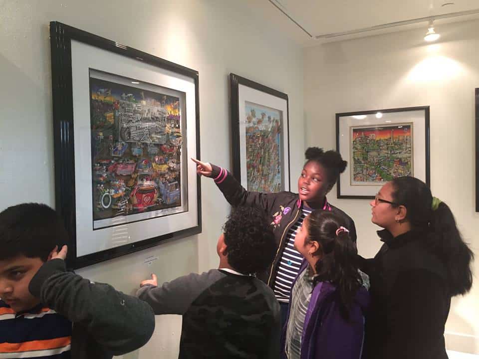 Sameira Brown (pointing) discusses a Fazzino work with classmates