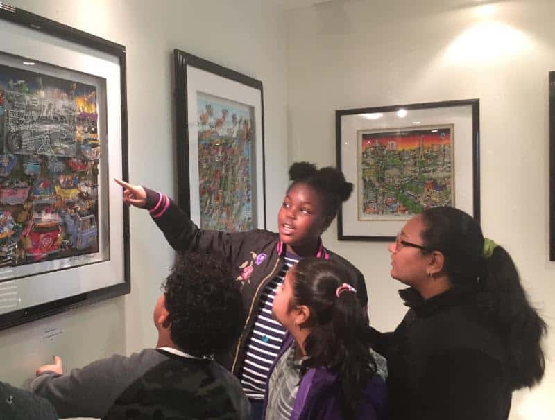 Trinity fifth-grader Sameira Brown (pointing) discusses a Fazzino work with classmates.