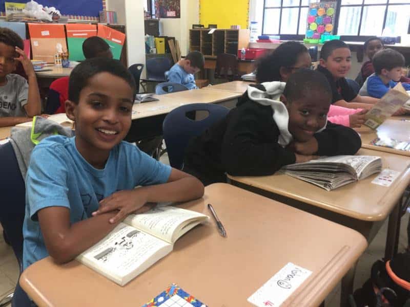Webster fourth-grader Rohan Ross (left), Anthony Guimaras and classmates enjoy a book of their choice as the readathon begins.