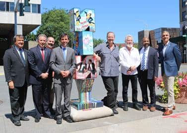 Pictured from left to right: County Executive George Latimer, City Manager Chuck Strome, Councilmember Barry Fertel, Mayor Noam Bramson, Charles Fazzino, Councilmember Ivar Hyden, Councilmember Jared Rice, Commissioner of Development Luiz Aragon