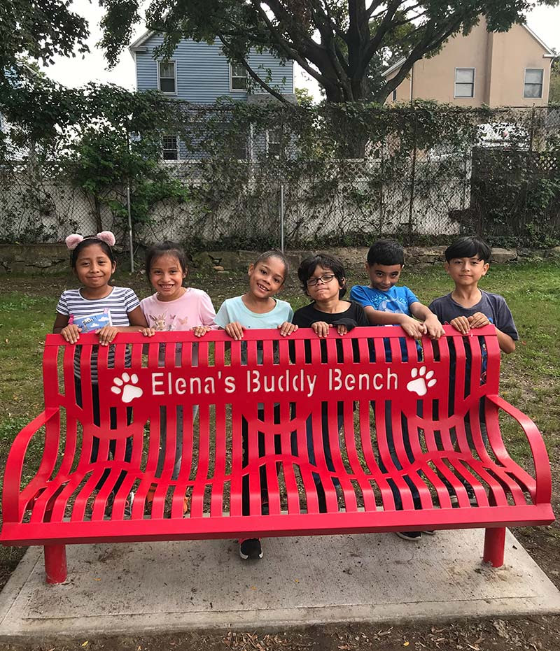 Jefferson Elementary School unveiled a new Buddy Bench in memory of teacher Elena Braia, who passed away two years ago. Buddy Benches help school children make new friends.