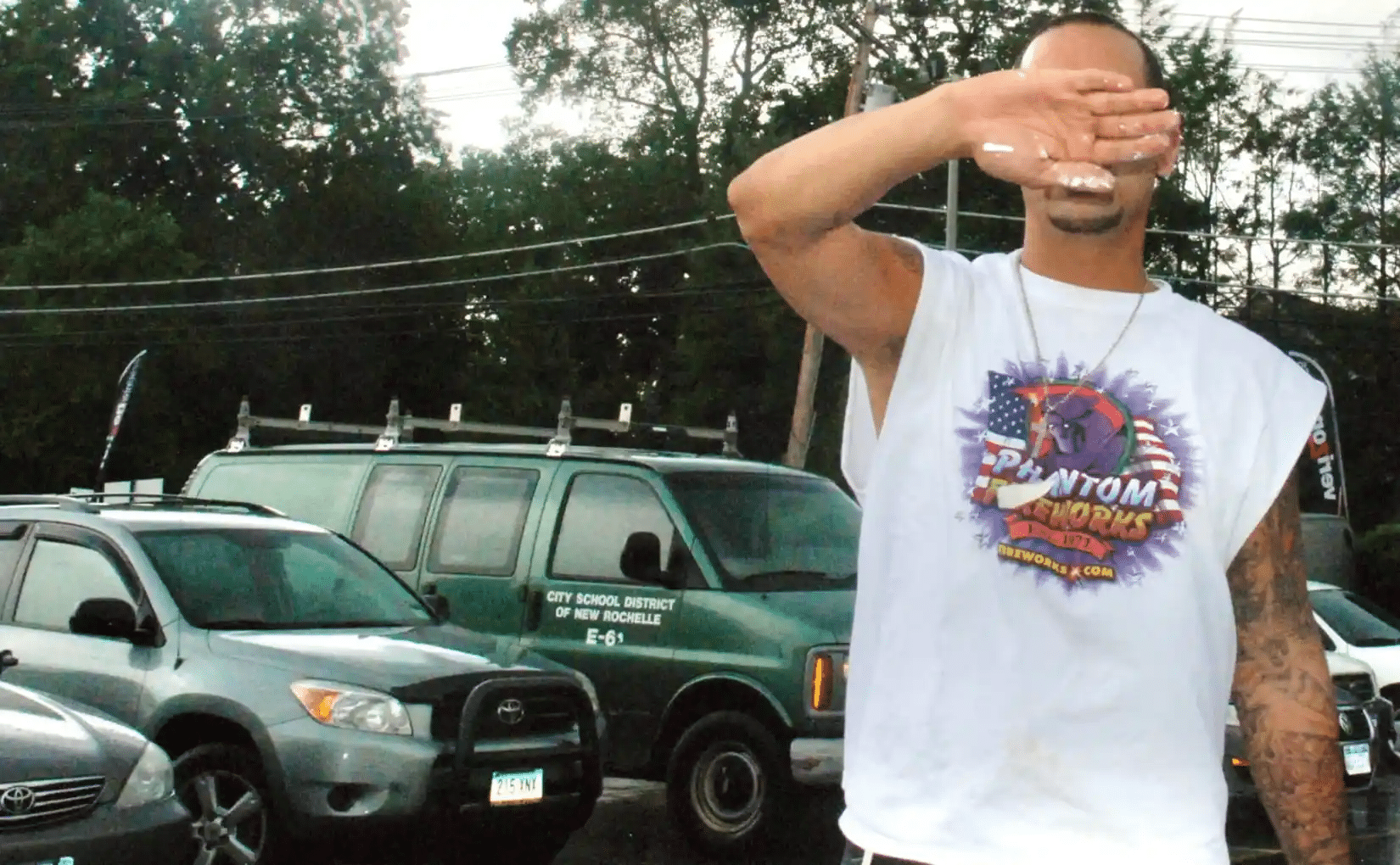 Apicella hides his facing after threatening Cox and his wife, a special education teacher. Both worked for the New Rochelle Board of Education at the time.